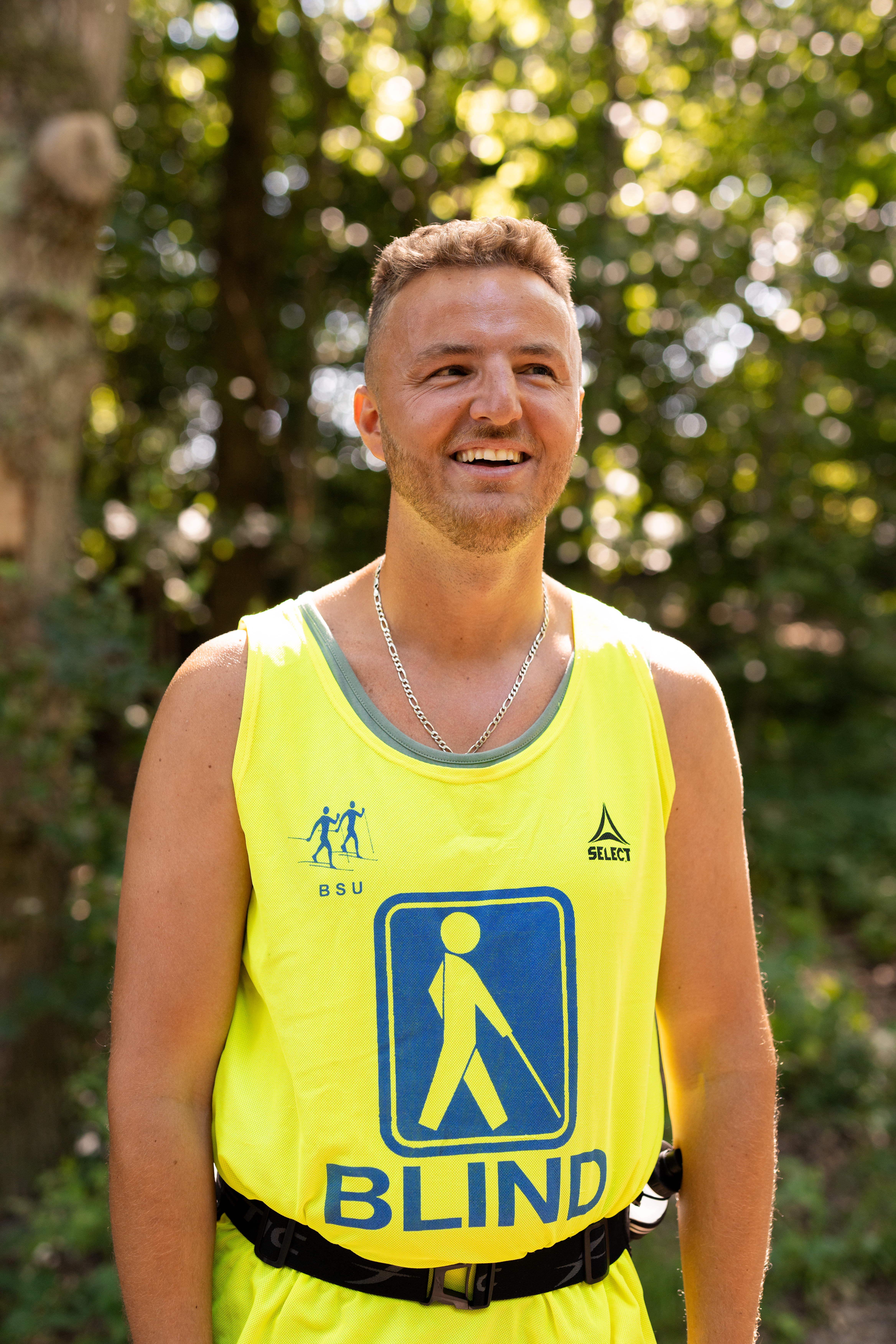 Portrait of Edis smiling in yellow vest